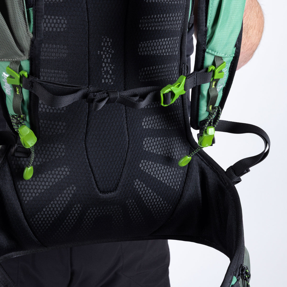 Close-up of a black backpack with green straps on a white background