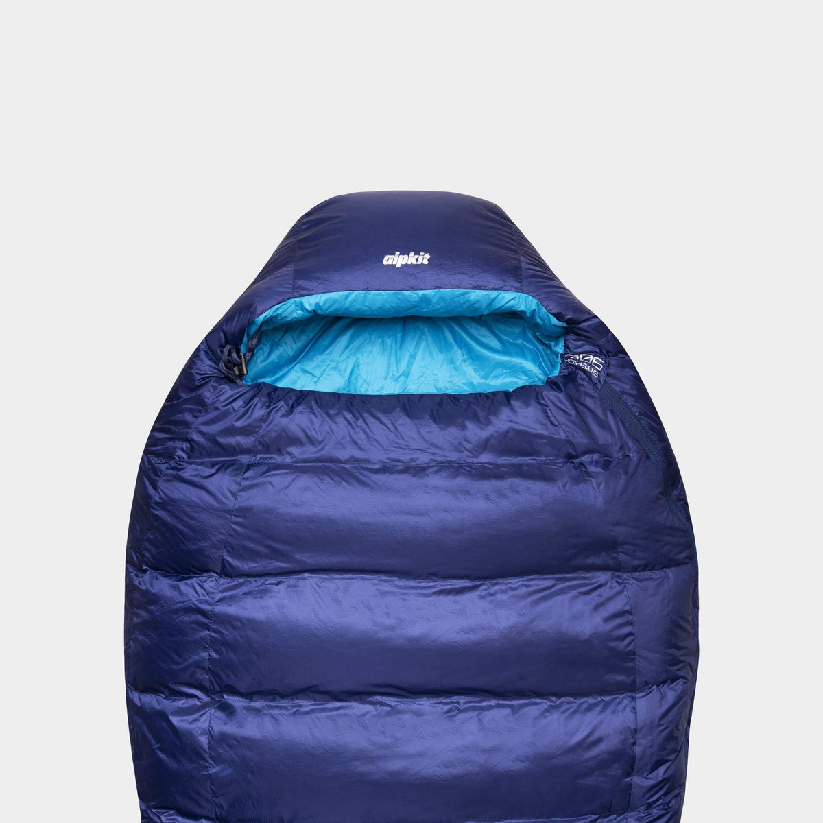 A blue SkyeHigh 900 sleeping bag with a visible blue interior lining and the Alpkit logo on the top.