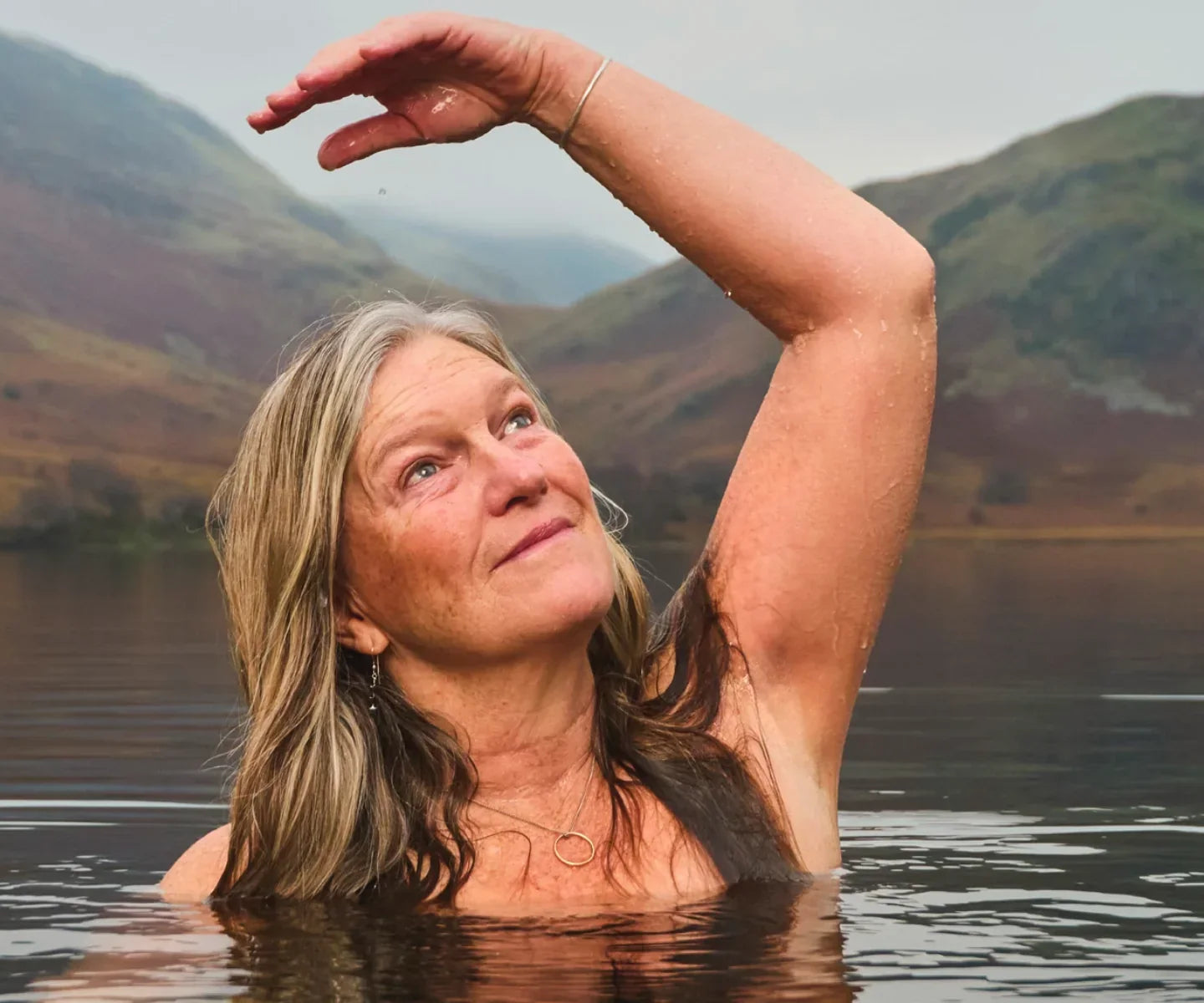 Woman swimming in a natural lake