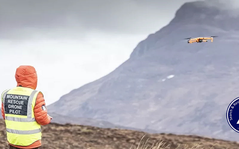 A search and rescue drone in flight over hill terrain