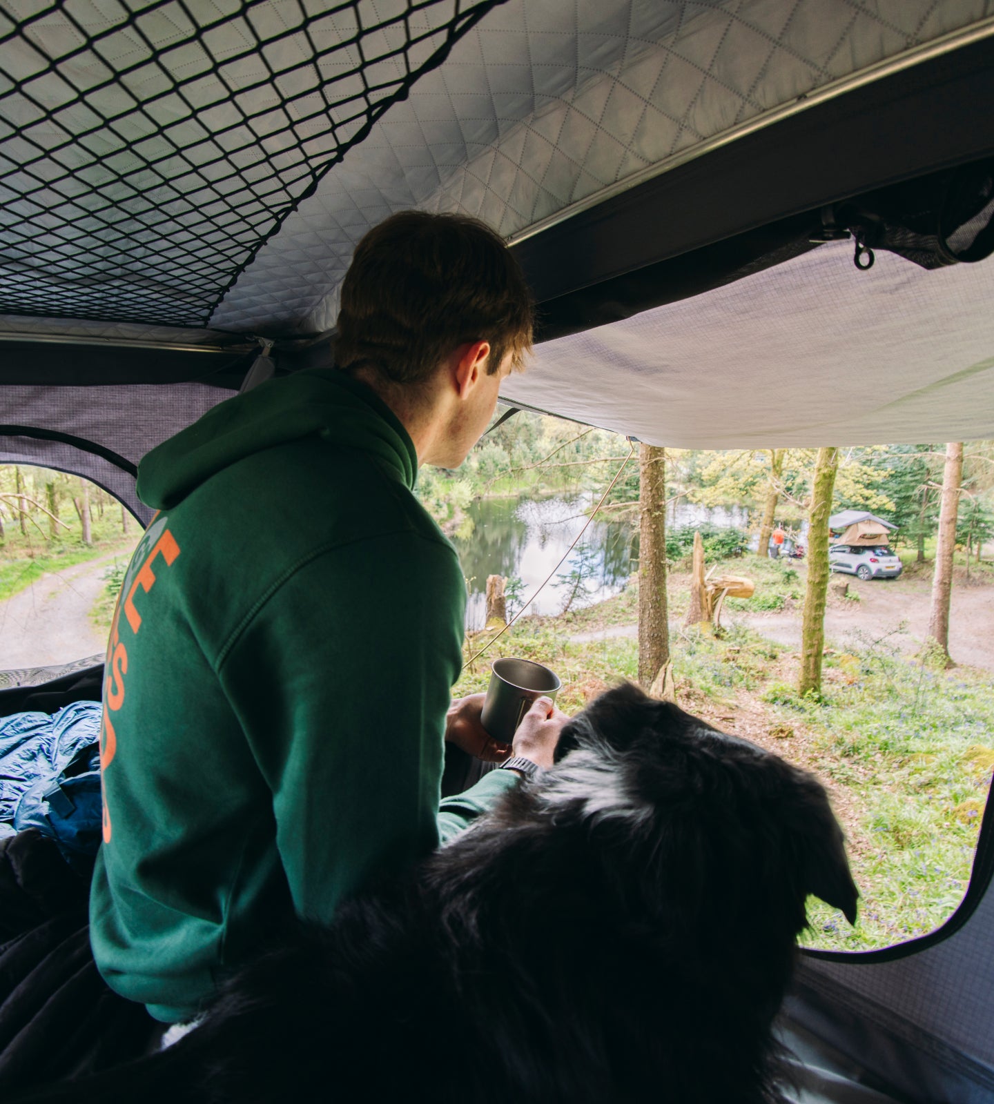Camper and dog in roof tent