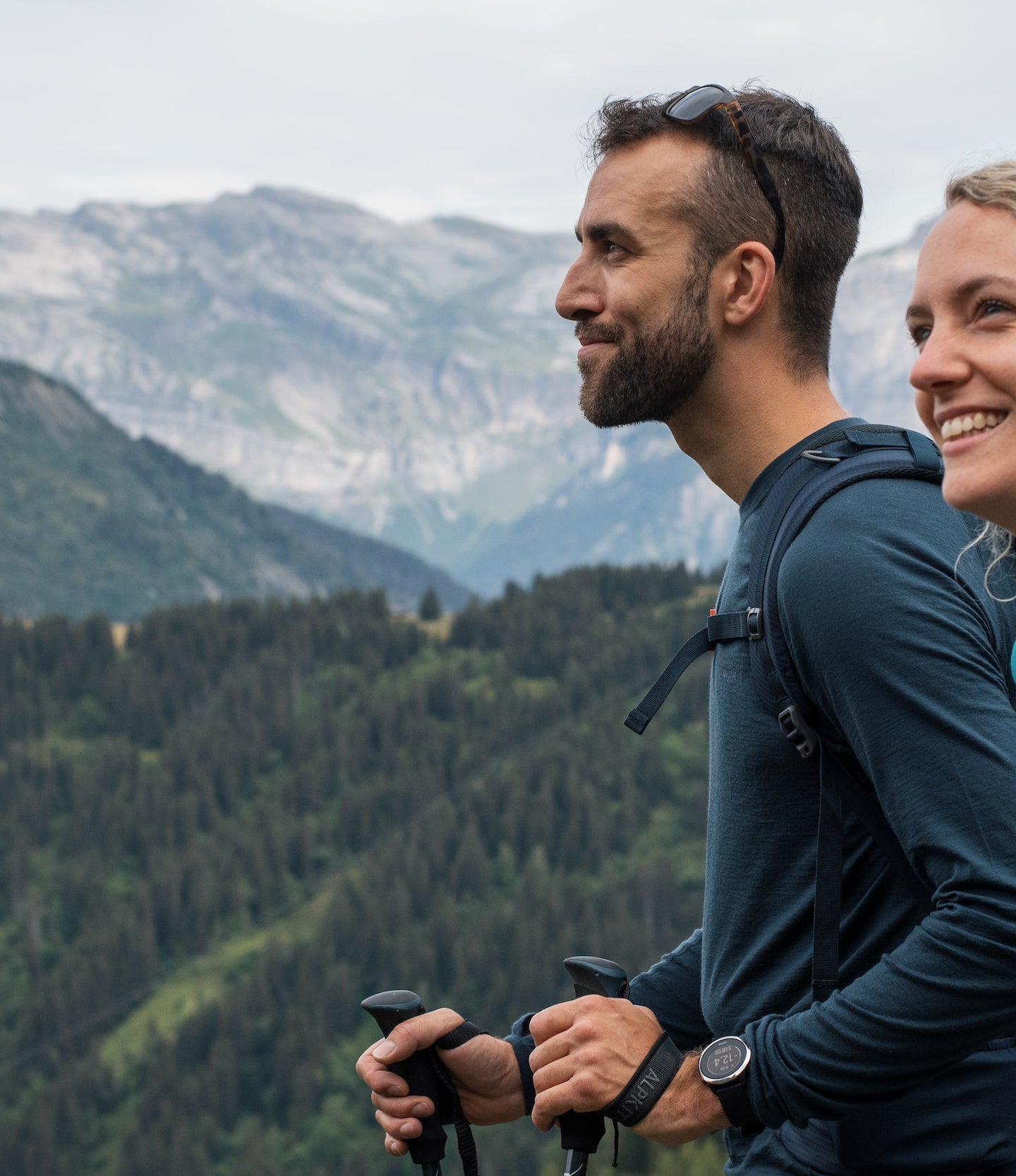 A man and a women trekking in Merino wool base layers in the French Alps