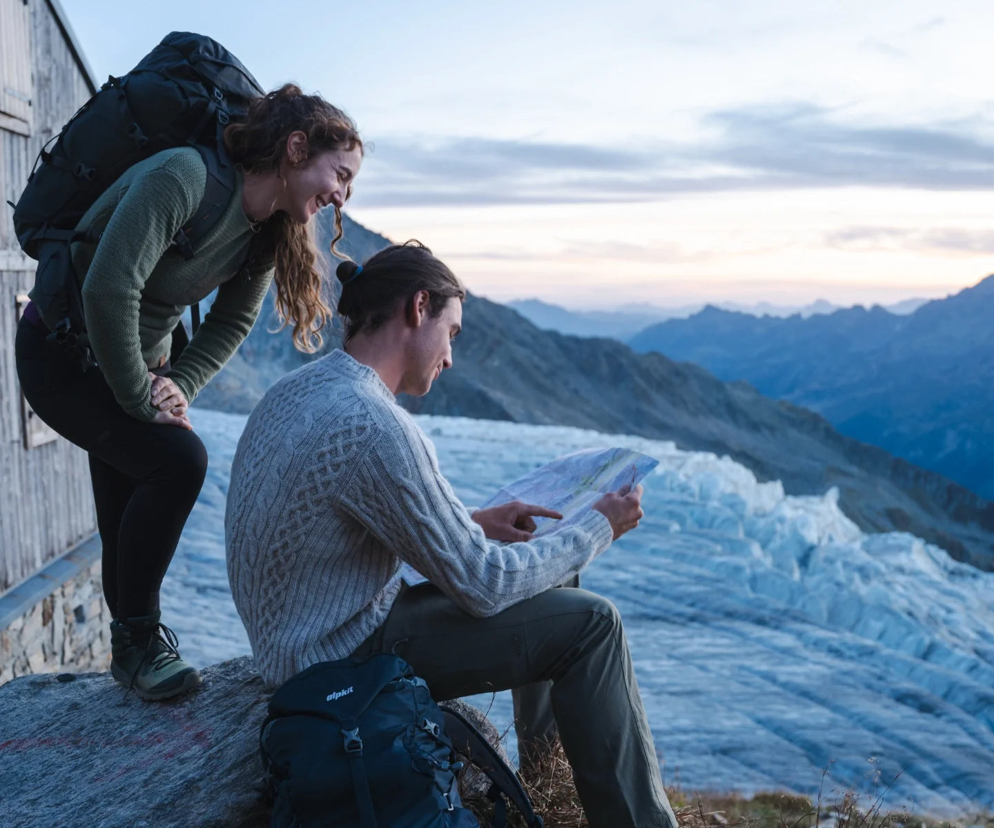Hikers in alpine hut wearing wool clothing